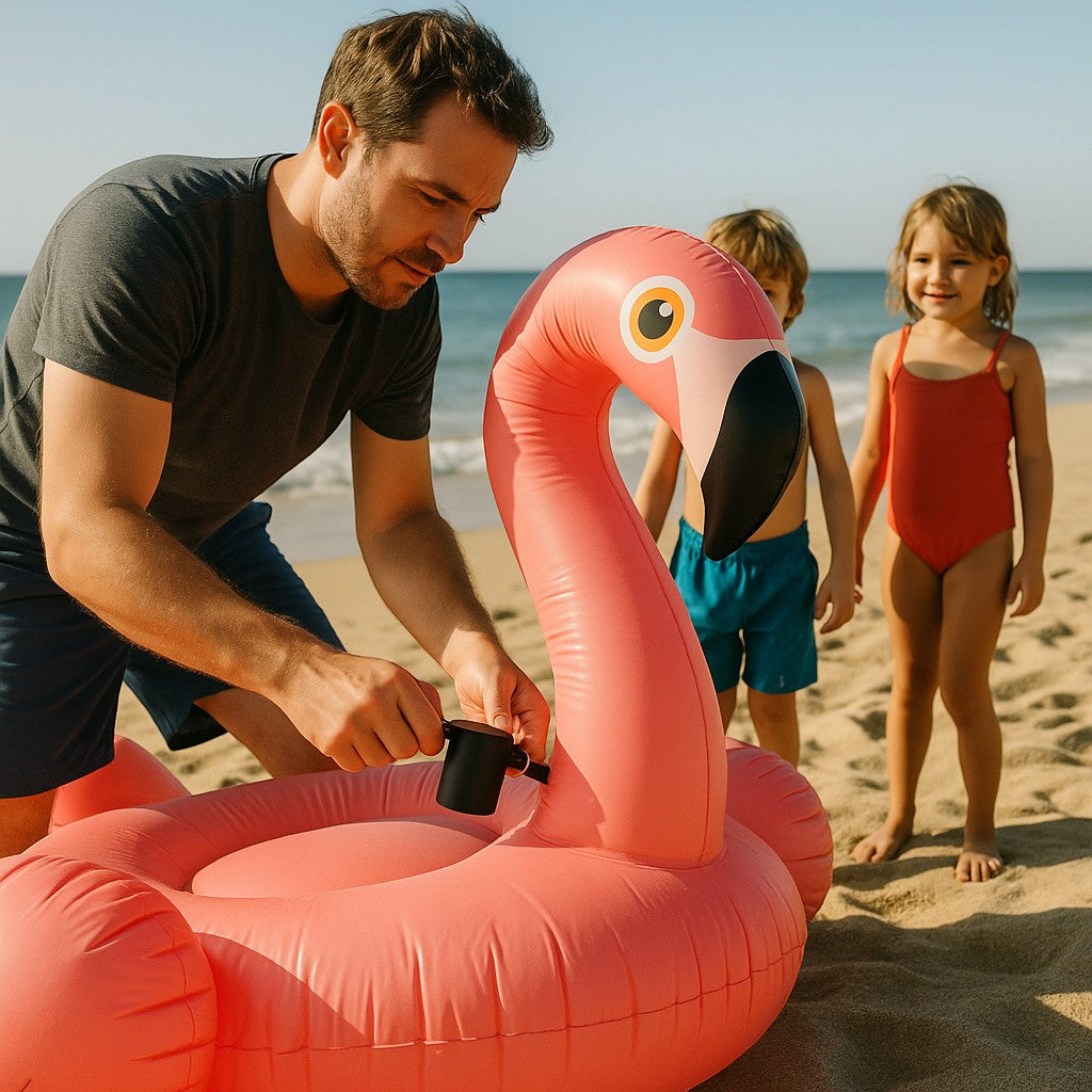 Dad inflating giant flamingo pool float at beach