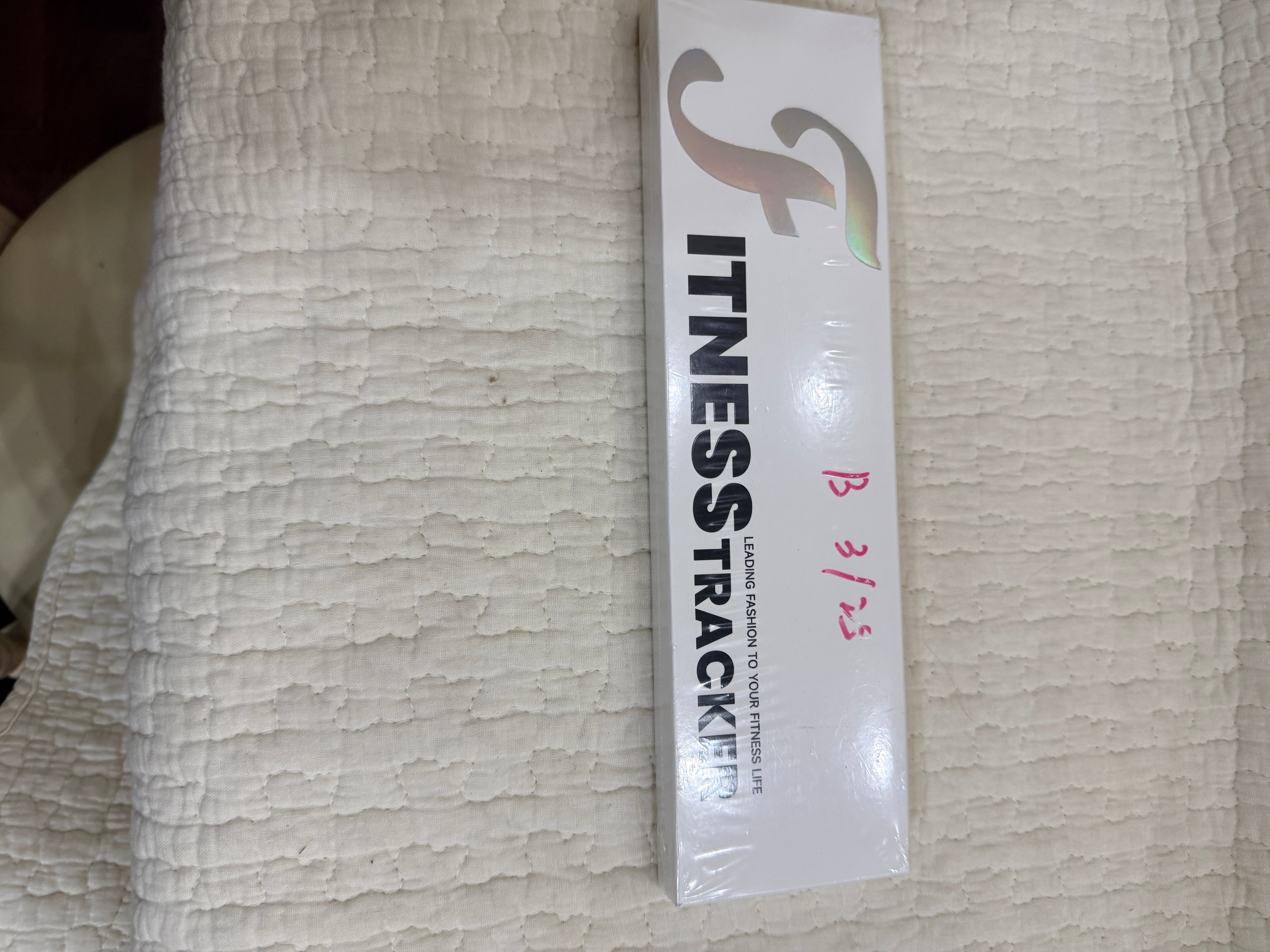 Slim white fitness tracker package front