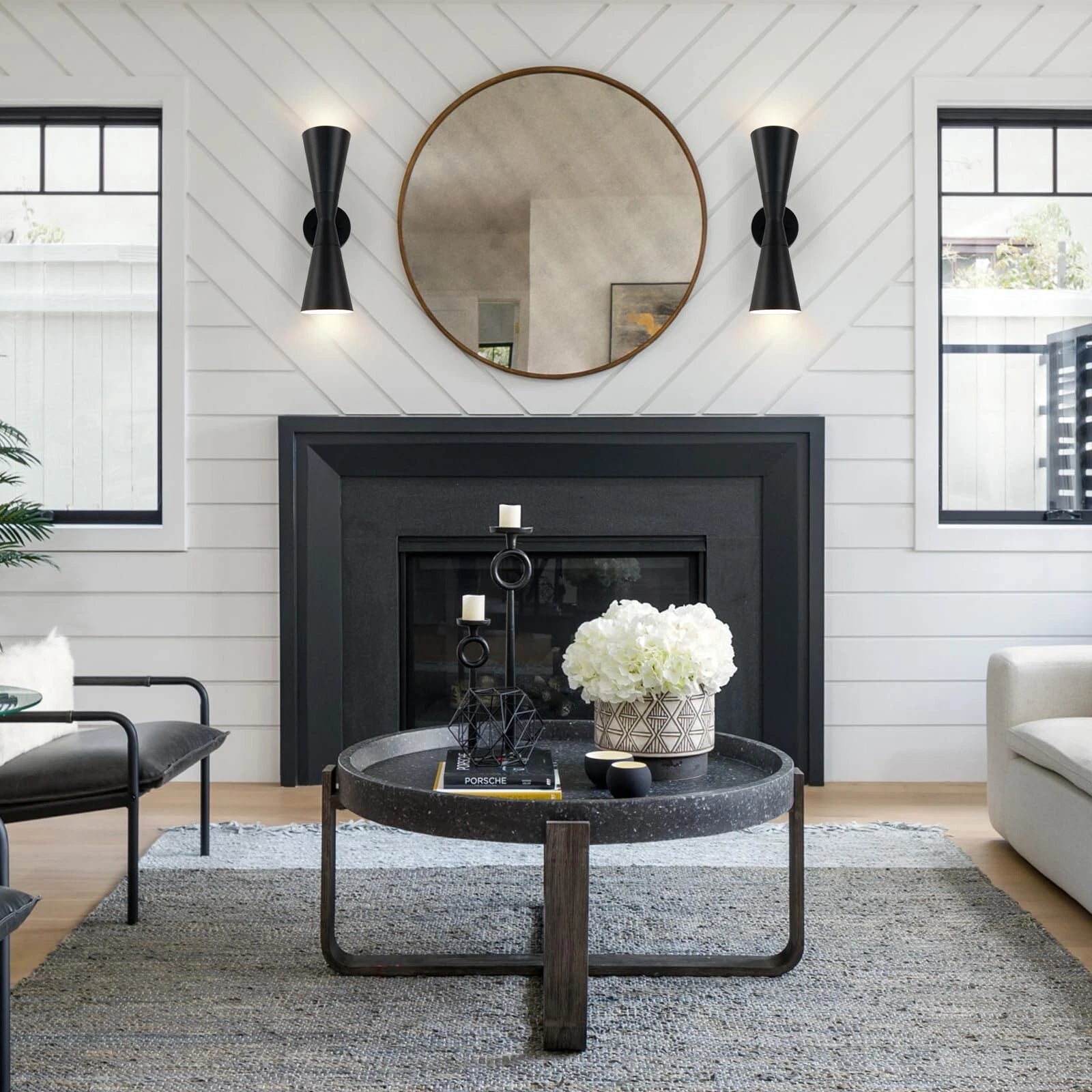 Modern black wall sconce showcases a refined up-and-down lighting design